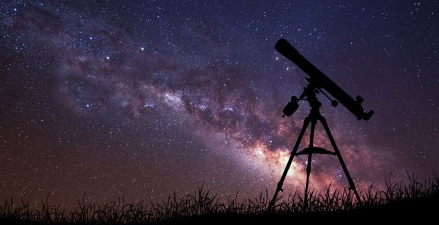 A telescope points into a galaxy-filled night sky, representing perimeterless data security.