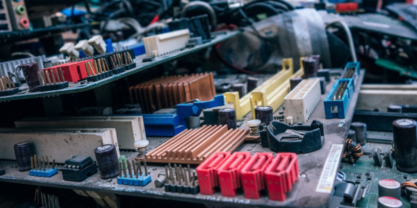 Bits and pieces of electronics are neatly arrayed on a worktable.