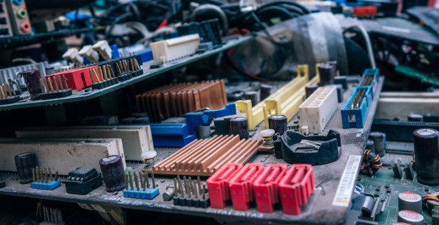 Bits and pieces of electronics are neatly arrayed on a worktable.