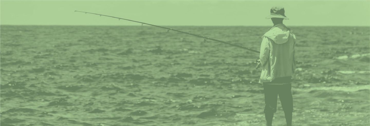 Man phishing in the ocean, overlaid with a color filter in Duo green