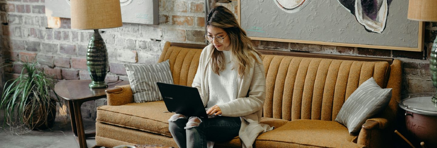 Woman working on a laptop at a coffee shop