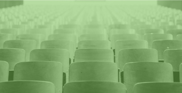 An empty university classroom, overlaid with a color filter of Duo green