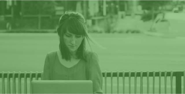 Stylized image of a woman working on a laptop at a cafe