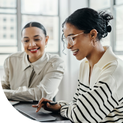 Women smiling, logging in to computer, happy teamwork