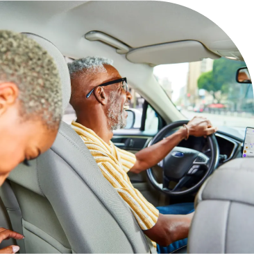 Ride share driver with passenger in car.